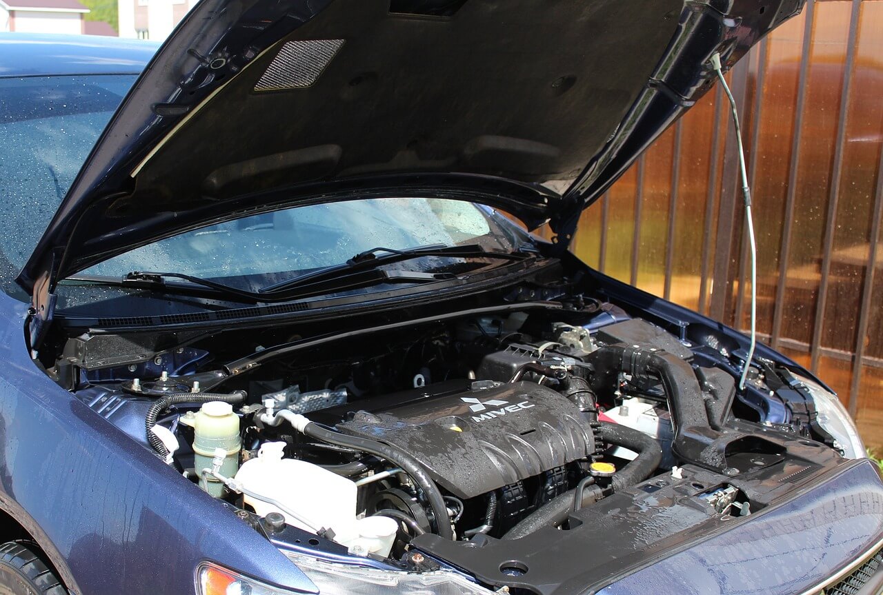 The engine bay of a car with an MOT failure certificate.