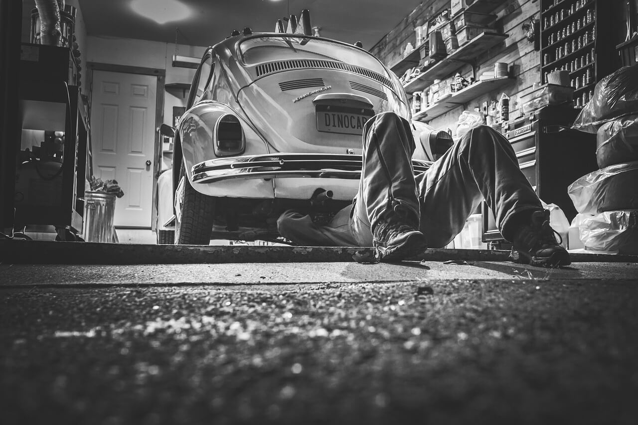 A mechanic servicing a car engine.